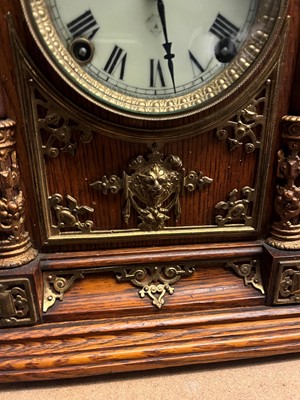 Lot 384 - A oak and gilt-metal mantel clock