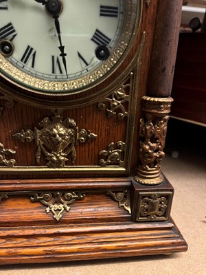 Lot 384 - A oak and gilt-metal mantel clock