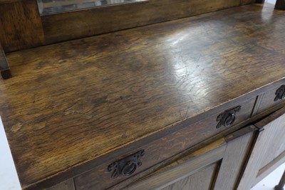 Lot 621 - An Art and Crafts oak mirror back cabinet sideboard