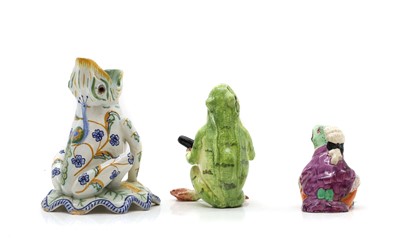 Lot 320 - Three pottery figures of frogs