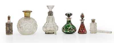 Lot 48 - A collection of glass, silver, and white metal mounted scent bottles