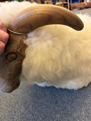 Lot 532 - A 'Goring Hotel' carved oak and wool sheep stool