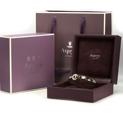 Lot 136 - An 18ct gold diamond 'Bond' bangle, by Asprey