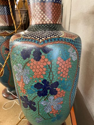 Lot 34 - A pair of polychrome cloisonné enamel lamps