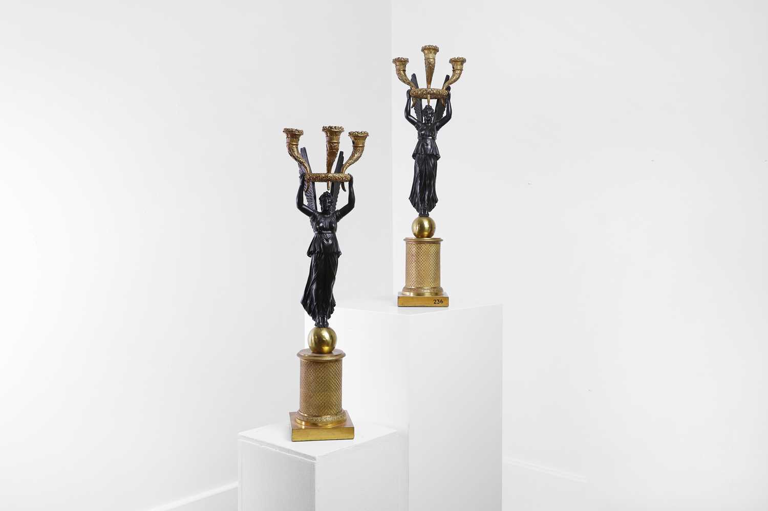 Lot 81 - A pair of Empire ormolu and patinated bronze candelabra