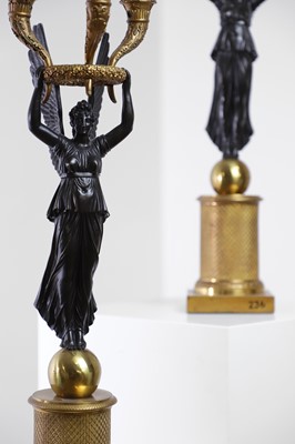 Lot 81 - A pair of Empire ormolu and patinated bronze candelabra