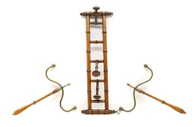 Lot 448A - A pair of mahogany and brass wig hangers, and a turned rack