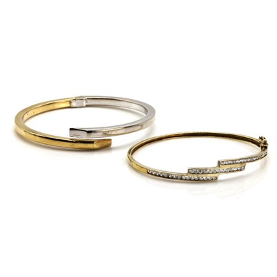 Lot 315 - A 9ct gold two colour gold bangle and a cubic zirconia set bangle