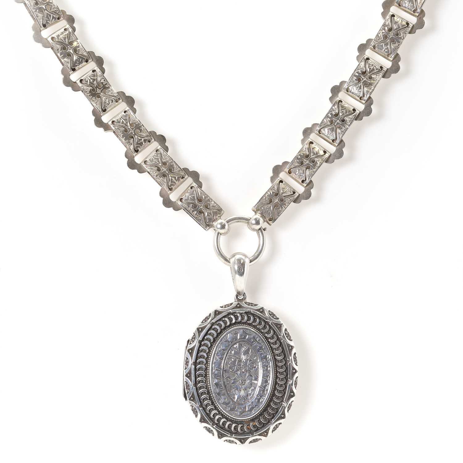 Locket Chain Plus Sign Lot 31 - A Victorian silver locket and chain,