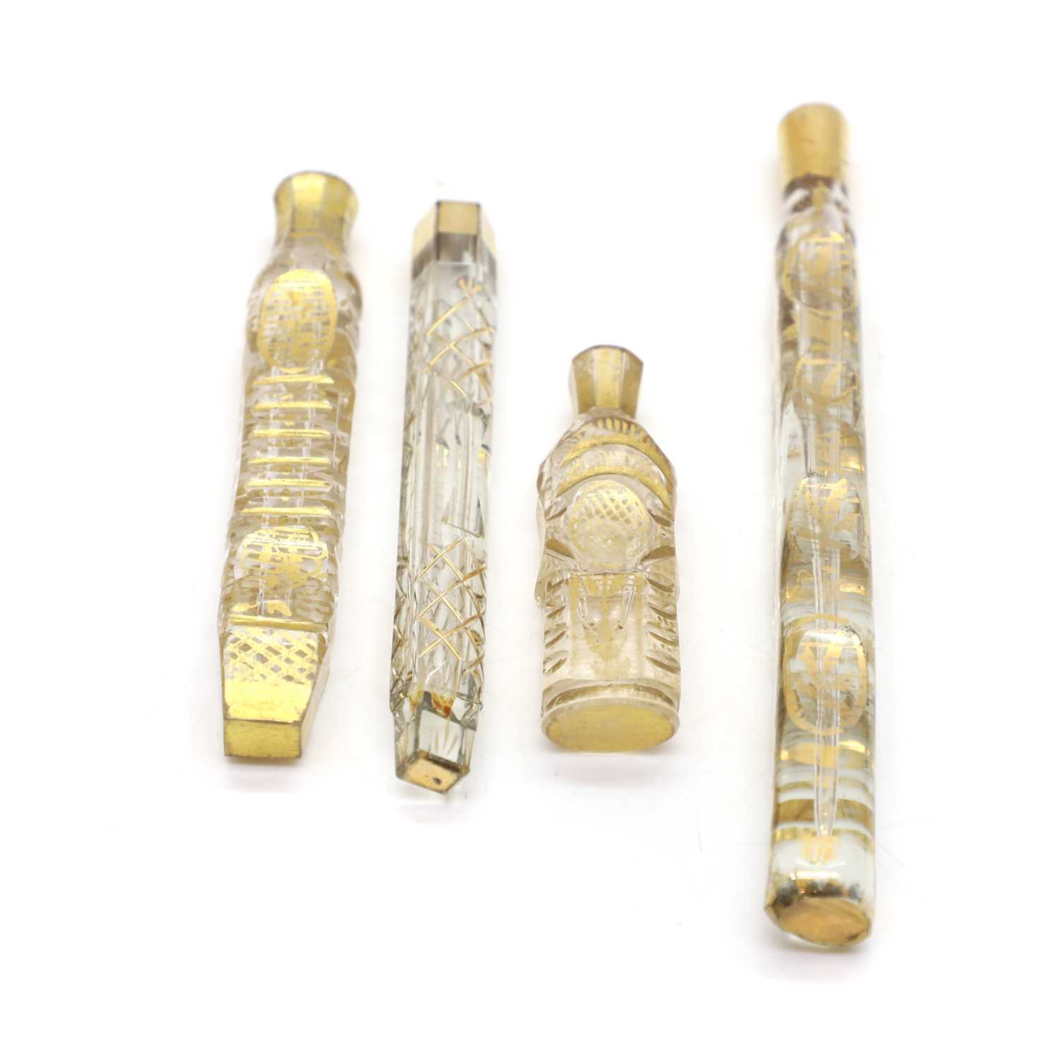 Lot 55 - Four cut glass and gilt tear dropper scent bottles