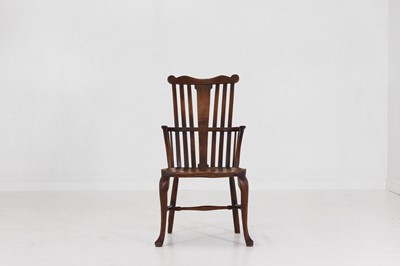 Lot 467 - A George III fruitwood and elm comb-back Windsor armchair