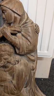 Lot 165 - A large carved walnut relief