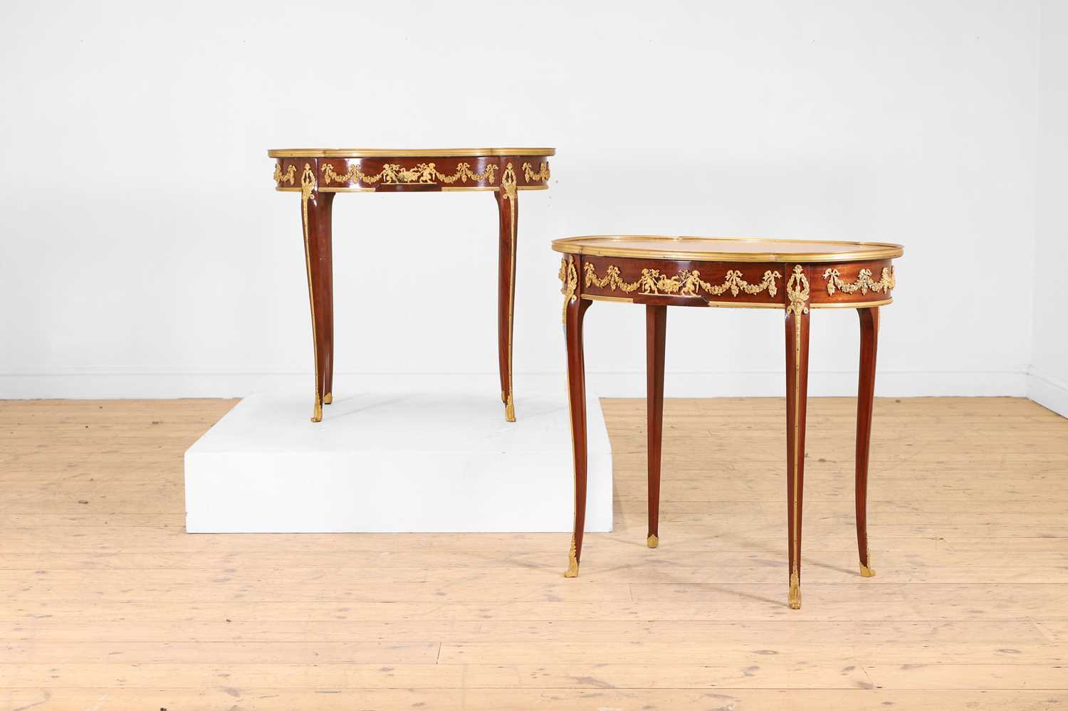 Lot 43 - A pair of Louis XVI-style kingwood and mahogany occasional tables