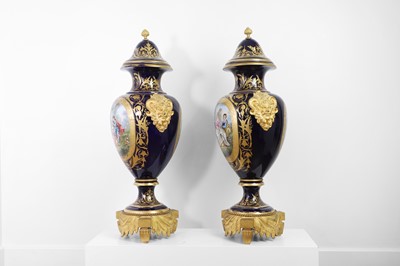 Lot 391 - A pair of large Sèvres-style porcelain vases and covers