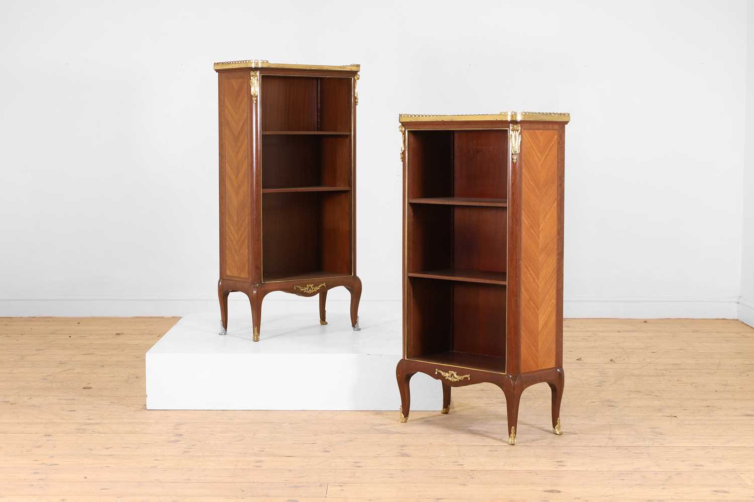 Lot 15 - A pair of small Louis XVI Transitional-style mahogany, tulipwood and gilt-bronze bookcases