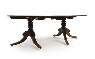 Lot 520 - A Regency-style mahogany twin pillar dining table