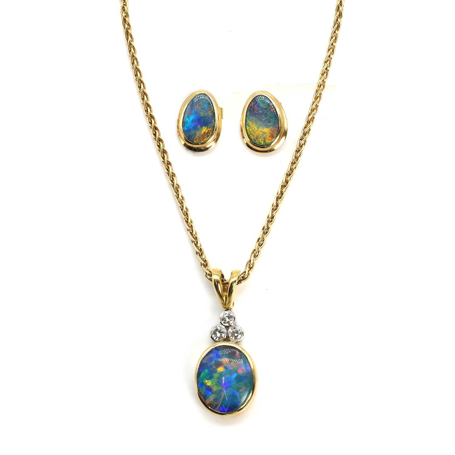 Lot 224 - An 18ct yellow and white gold black opal doublet and diamond pendant