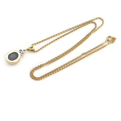 Lot 224 - An 18ct yellow and white gold black opal doublet and diamond pendant