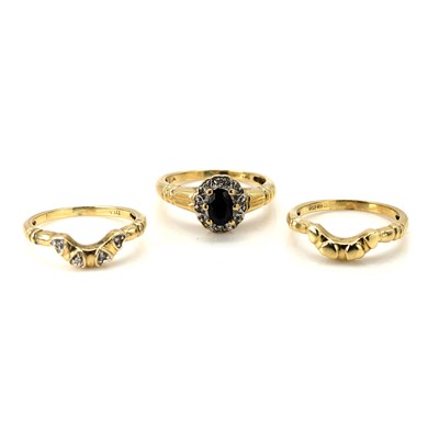 Lot 343 - A sapphire and diamond cluster ring and two ring guards