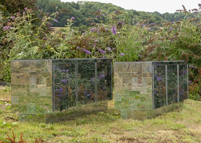 Lot A pair of polished steel 'Cityscape' cabinets