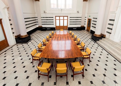 Lot 381 - A rosewood table and sixteen matching chairs