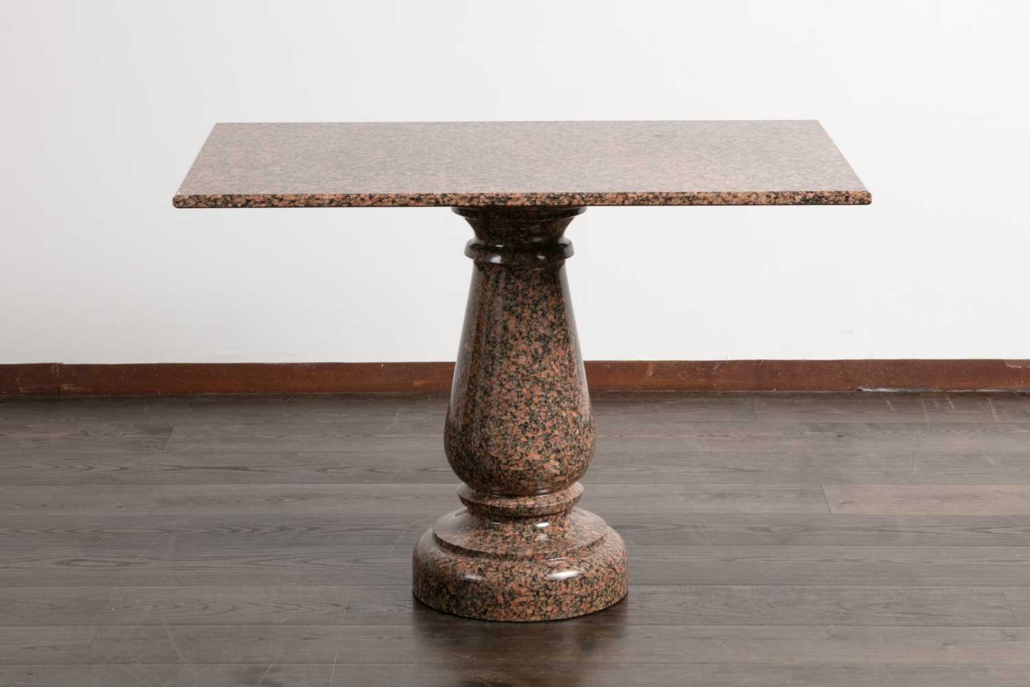 Lot 102 - A polished granite centre table