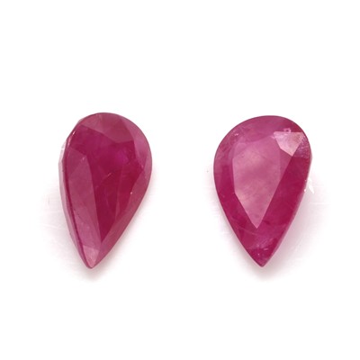 Lot 286 - † A pair of unmounted pear cut rubies