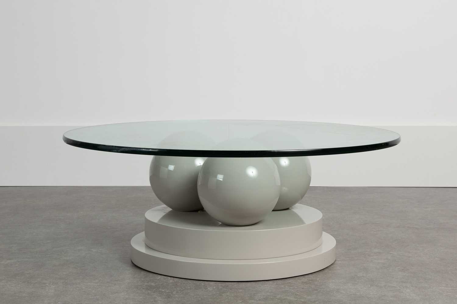 Lot 209 - A lacquered and glass coﬀee table