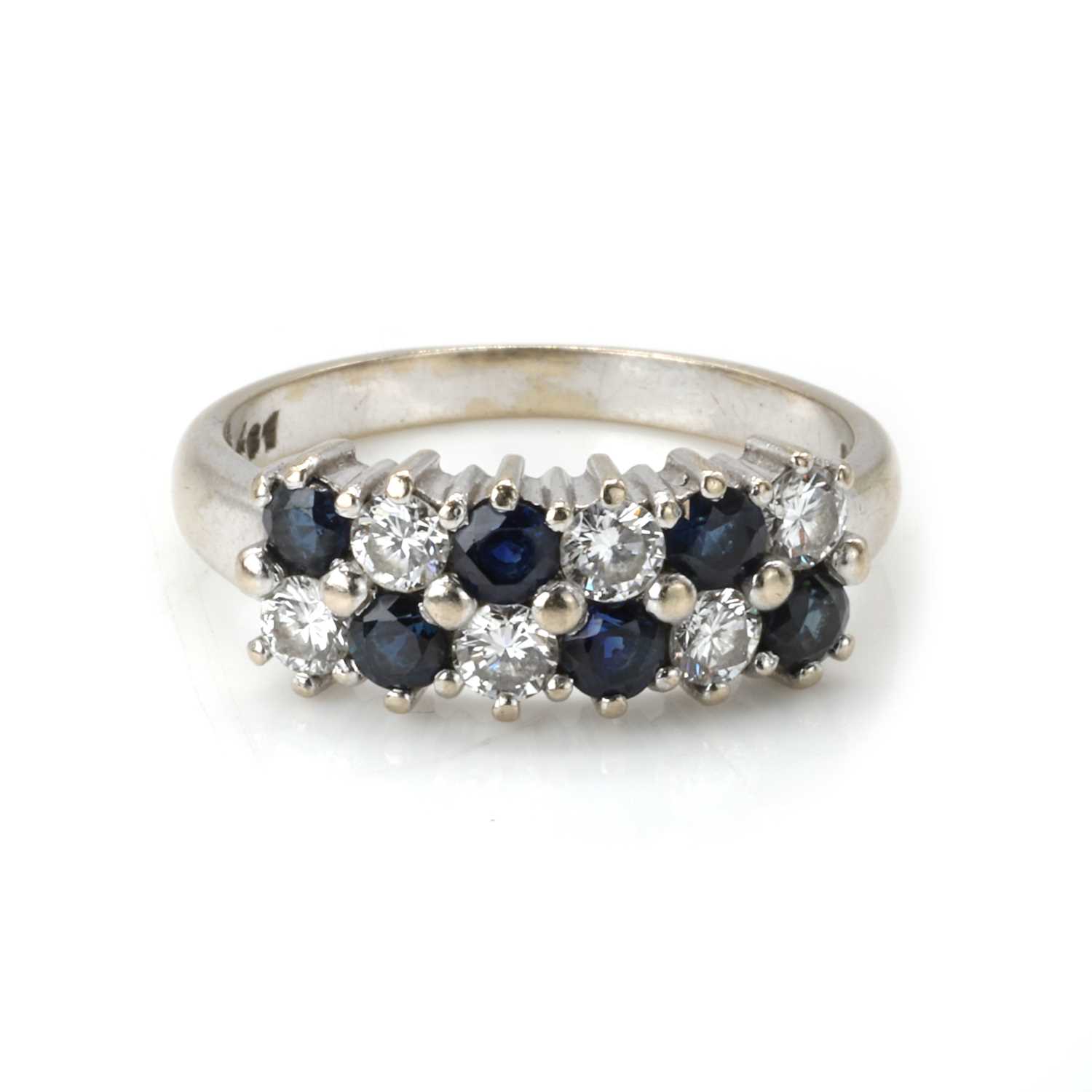 Lot 80 - An 18ct white gold sapphire and diamond cluster ring