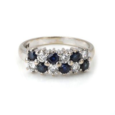 Lot 135 - An 18ct white gold sapphire and diamond cluster ring