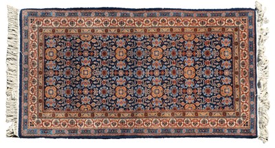 Lot 320 - A Persian rug navy fields with repeating stylised flowerhead motifs