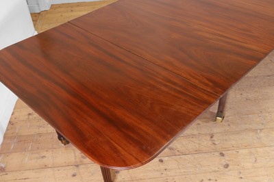Lot 571 - A large George III figured mahogany extending dining table in the manner of Gillows