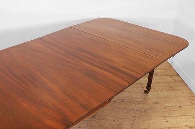 Lot 571 - A large George III figured mahogany extending dining table in the manner of Gillows