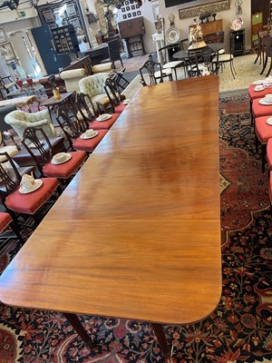 Lot 571 - A large George III figured mahogany extending dining table in the manner of Gillows