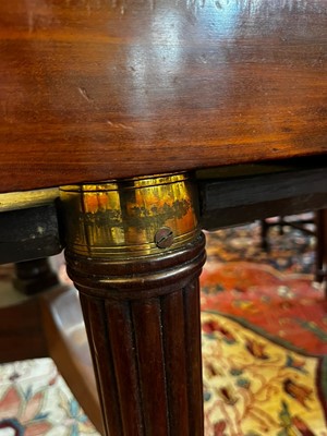 Lot 571 - A large George III figured mahogany extending dining table in the manner of Gillows