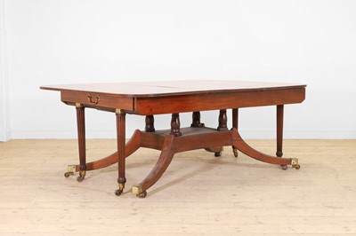Lot 571 - A large George III figured mahogany extending dining table in the manner of Gillows