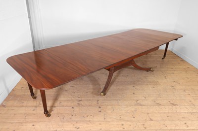 Lot 571 - A large George III figured mahogany extending dining table in the manner of Gillows