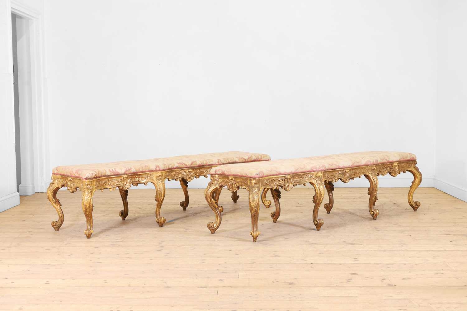 Lot 18 - A pair of carved giltwood and gesso stools or hall seats