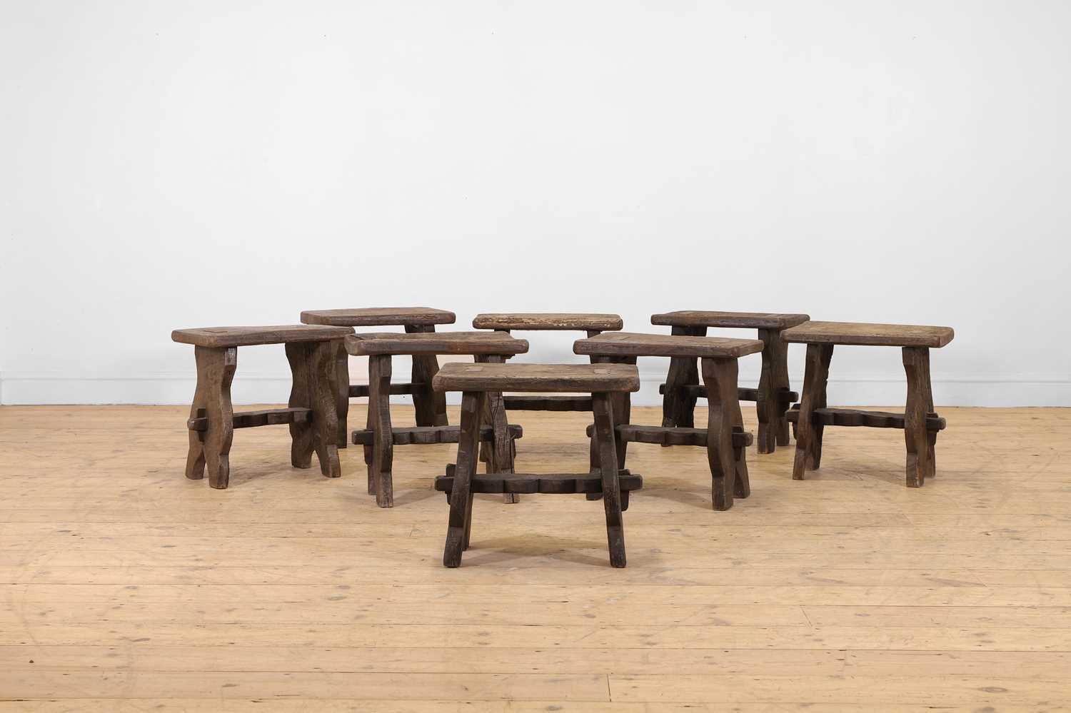 Lot 48 - A set of eight rustic oak stools