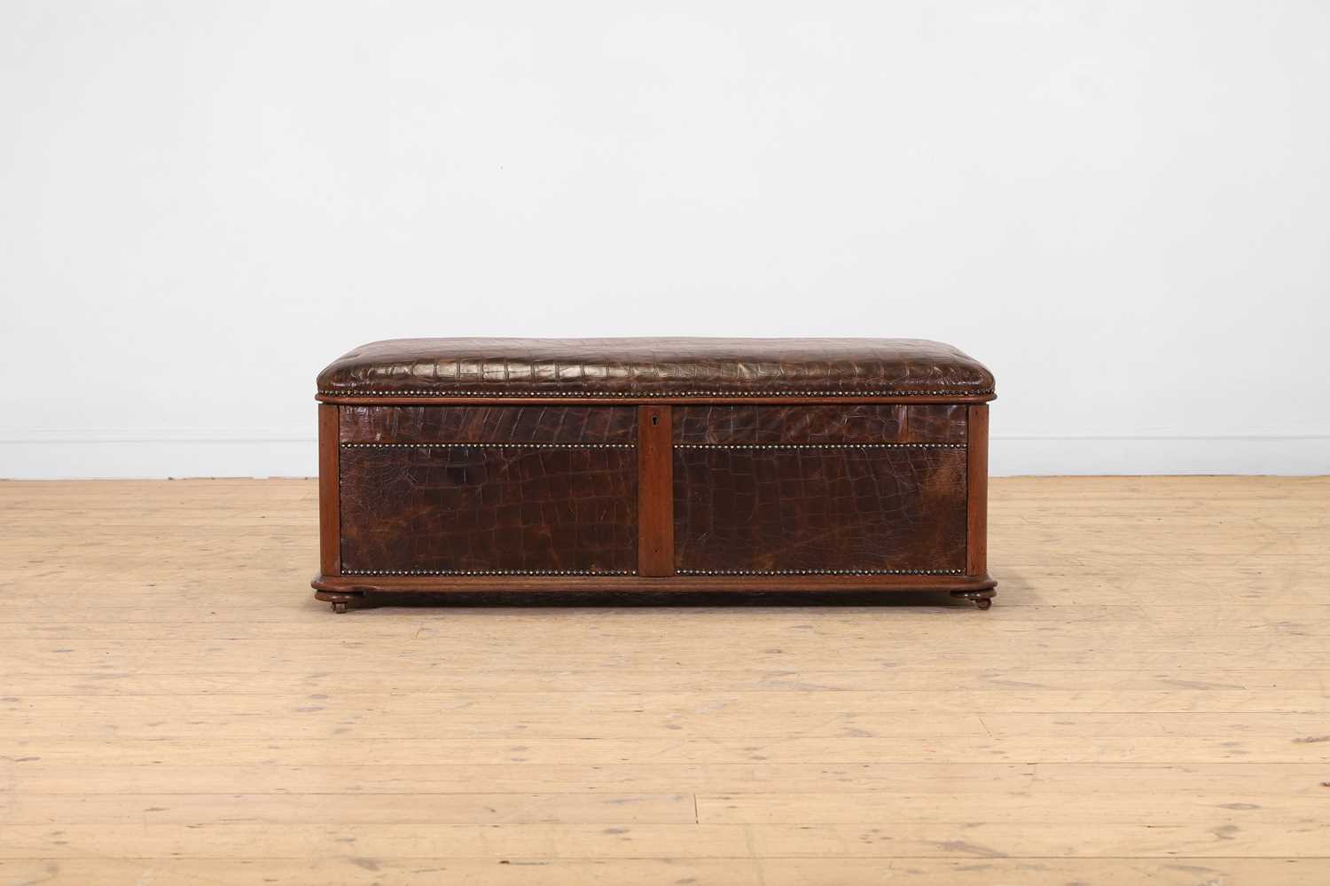 Lot 476 - A walnut and studded leather ottoman