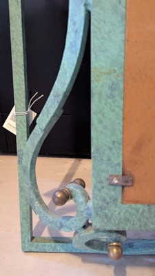 Lot 35 - An iron-verdigris-finished wall mirror