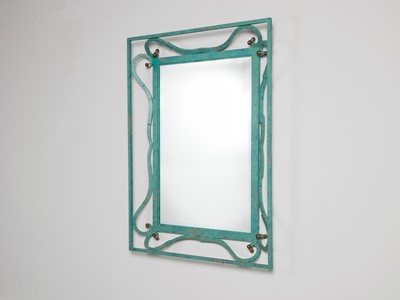 Lot 35 - An iron-verdigris-finished wall mirror