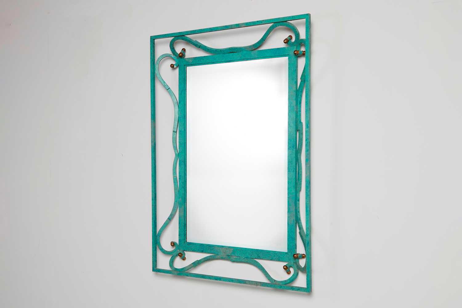Lot 35 - An iron-verdigris-finished wall mirror