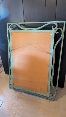 Lot 35 - An iron-verdigris-finished wall mirror
