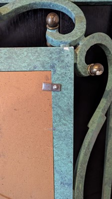 Lot 35 - An iron-verdigris-finished wall mirror