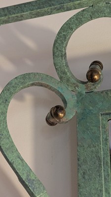 Lot 35 - An iron-verdigris-finished wall mirror