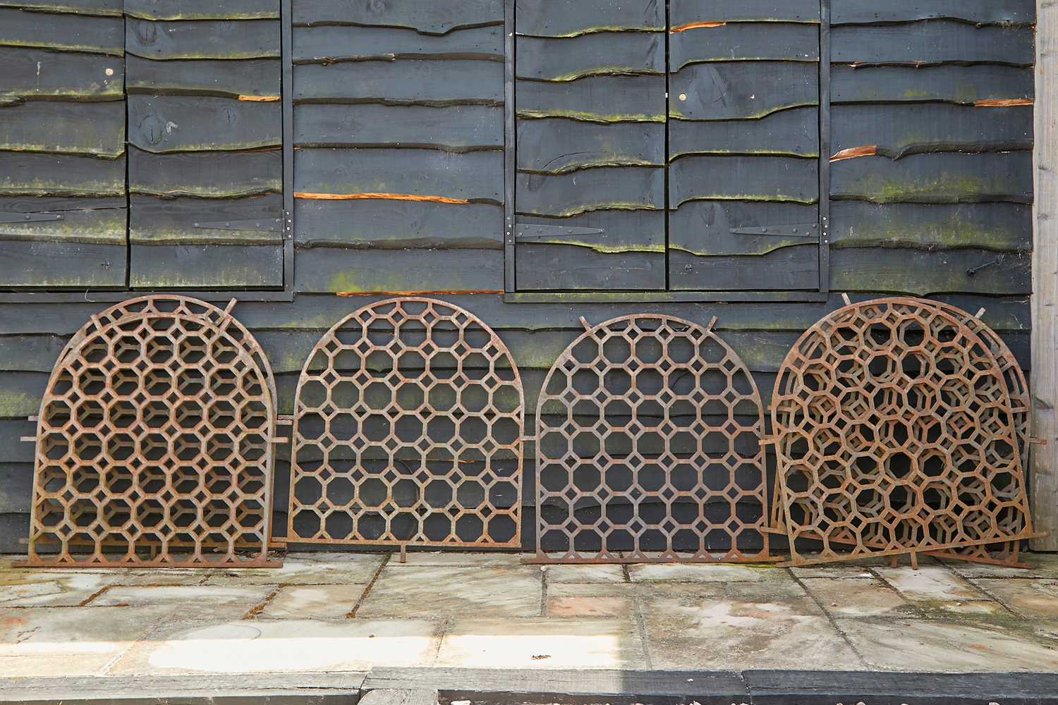 Lot 447 - A set of eight arched cast iron panels,