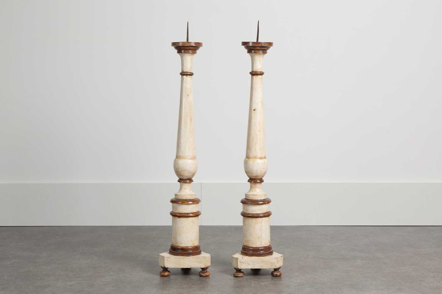Lot 86 - A pair of painted wood pricket candlesticks