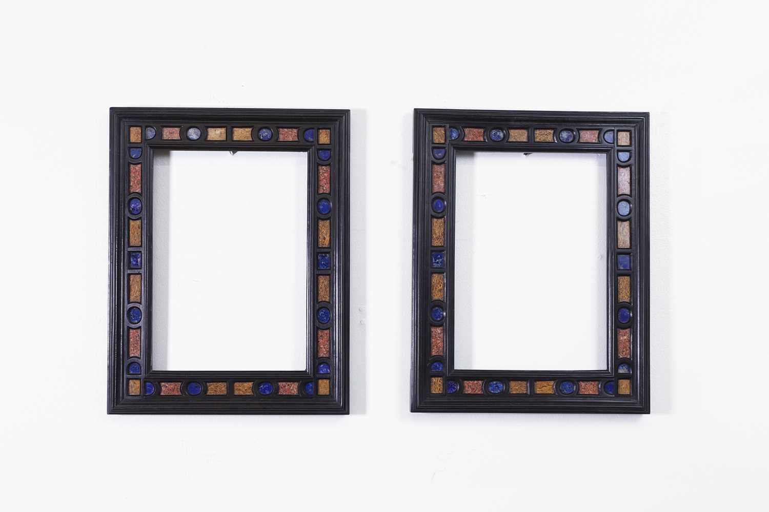 Lot 563 - A pair of ebony and specimen stone frames