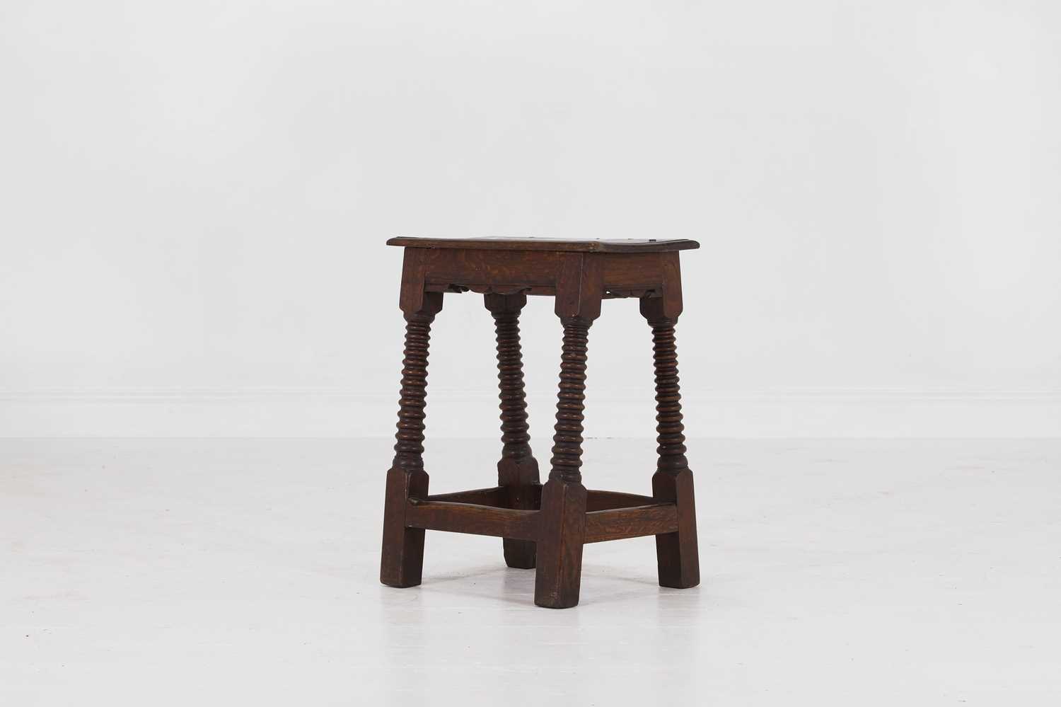Lot 39 - A carved oak joint stool